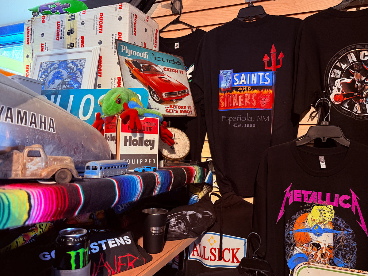 Printed shirts and vintage automotive memorabilia on display in the shop