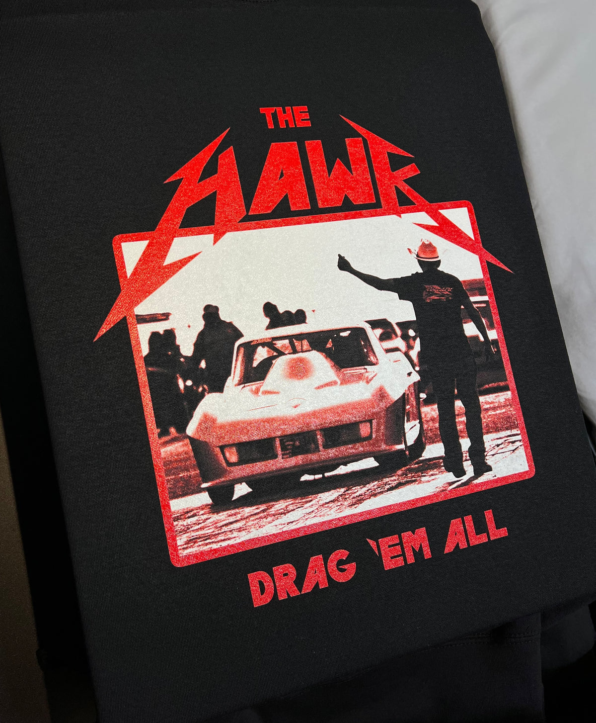The Hawk Drag Em All red and white artwork on a black shirt
