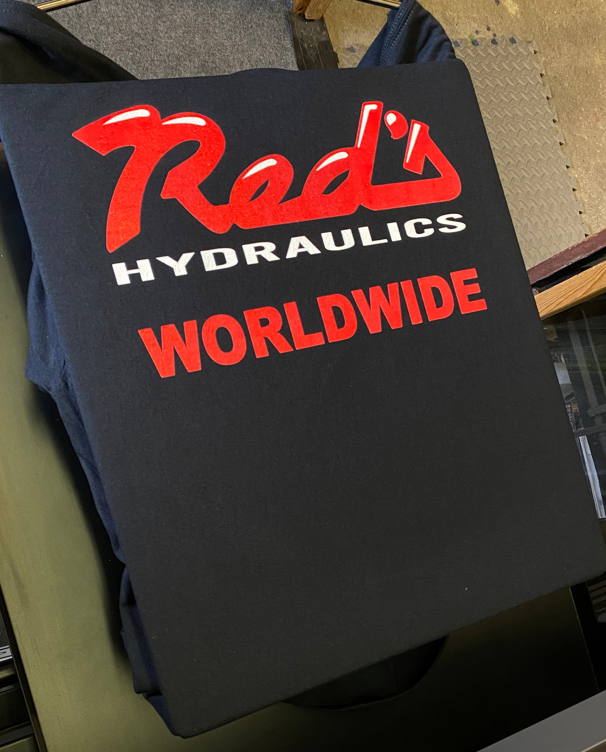 Reds Hydraulics Worldwide red and white print on a black shirt