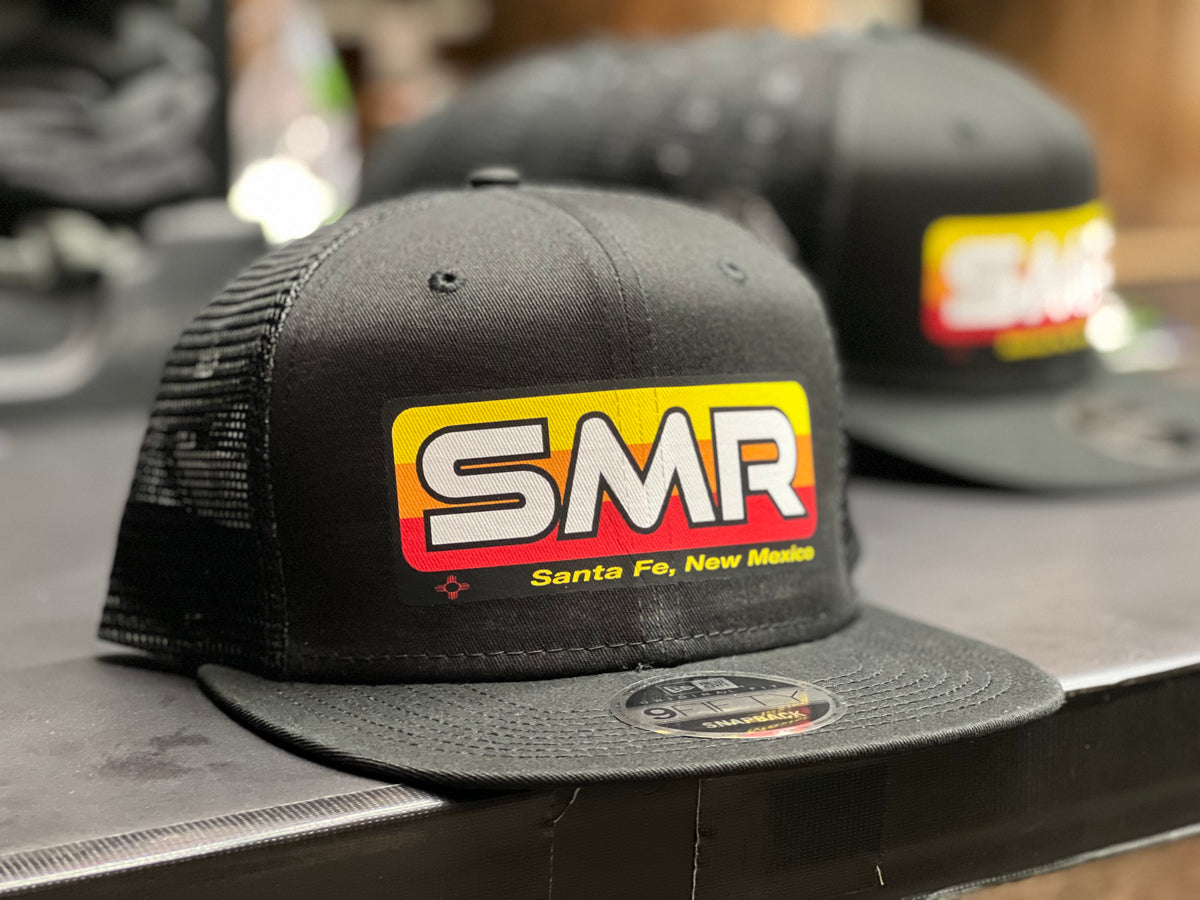 Black SMR trucker hat with a colorful Santa Fe New Mexico logo