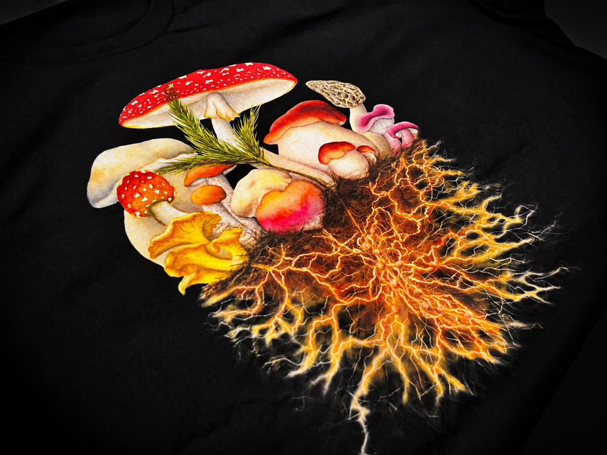 Vibrant mushrooms and branching orange roots printed on a black shirt