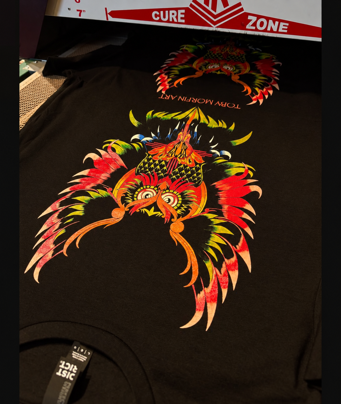 Colorful owl artwork printed on black shirts