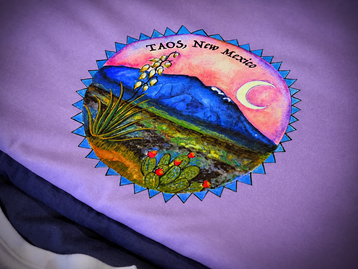 Colorful Taos New Mexico mountain and desert artwork printed on a lavender shirt